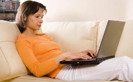 woman with laptop on the sofa